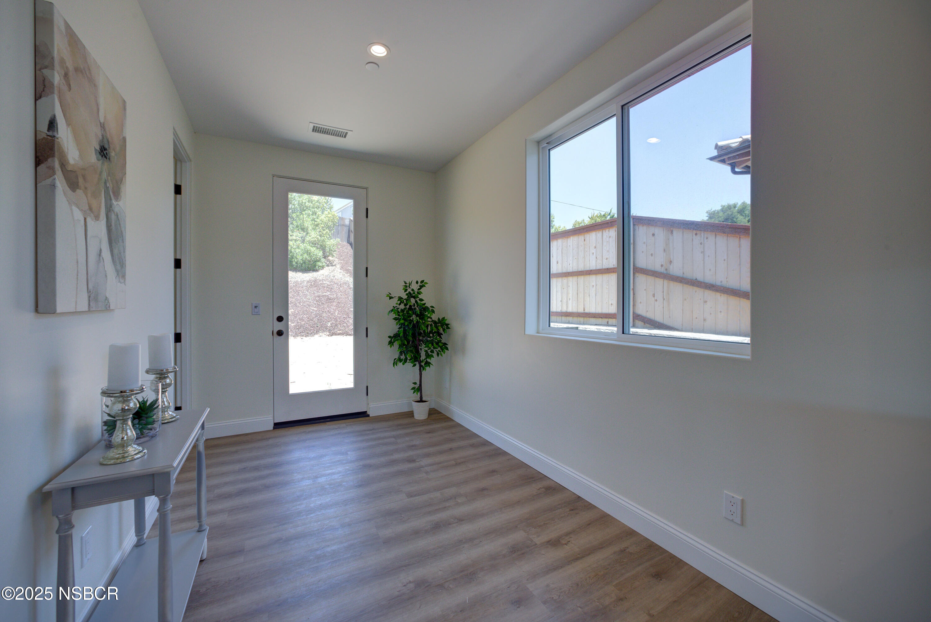1607 Tuscan Way Santa Maria, CA 93455 - Photo 14 of 37 a view of an empty room with wooden floor and a window