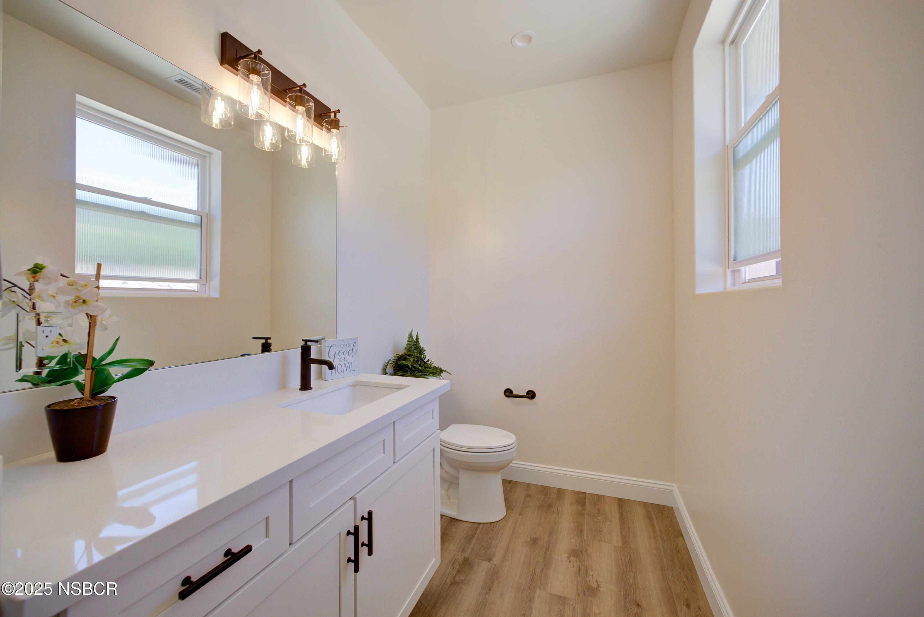 1607 Tuscan Way Santa Maria, CA 93455 - Photo 15 of 37 a bathroom with a sink a toilet and a mirror