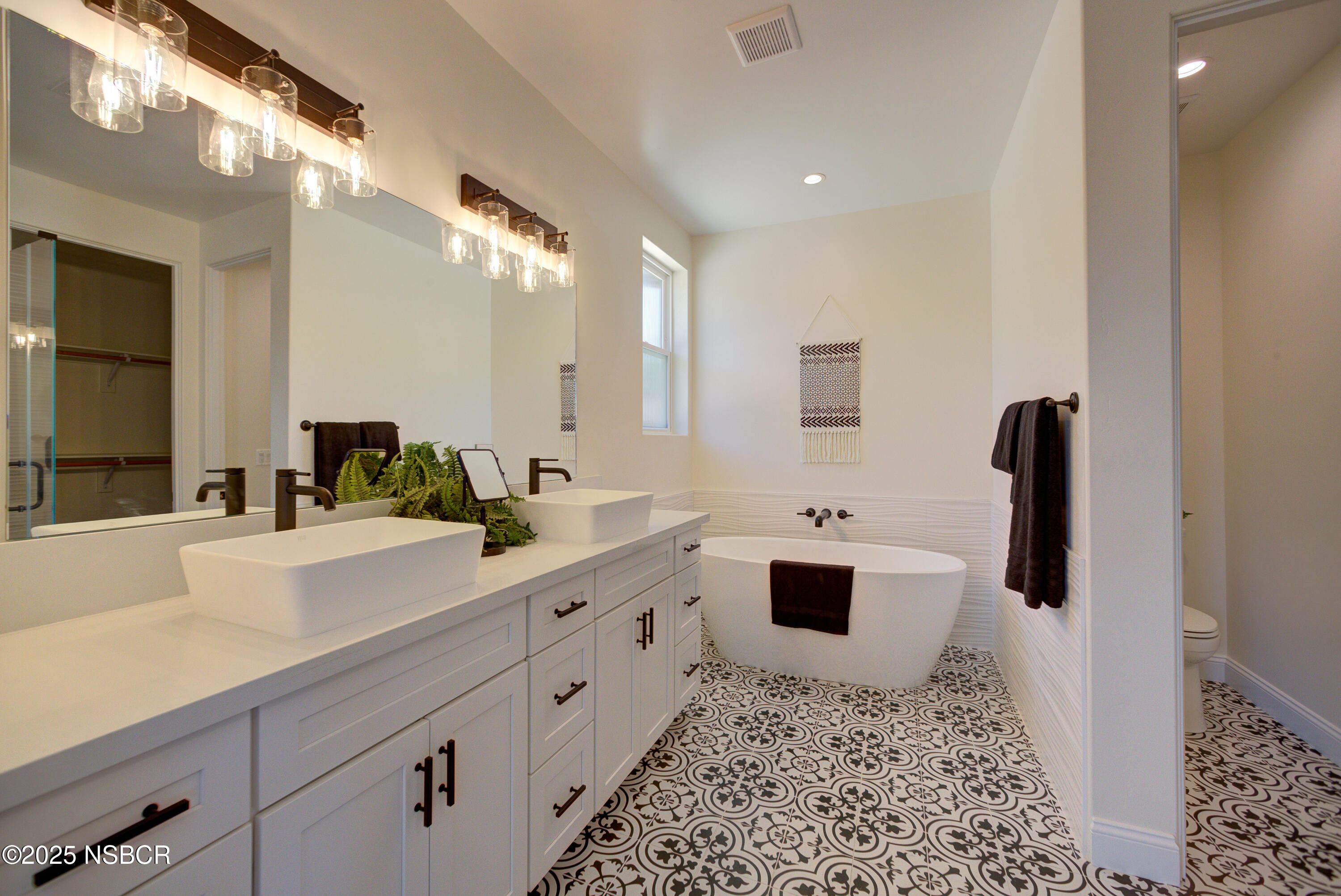 1607 Tuscan Way Santa Maria, CA 93455 - Photo 19 of 37 a bathroom with a double vanity sink toilet and mirror