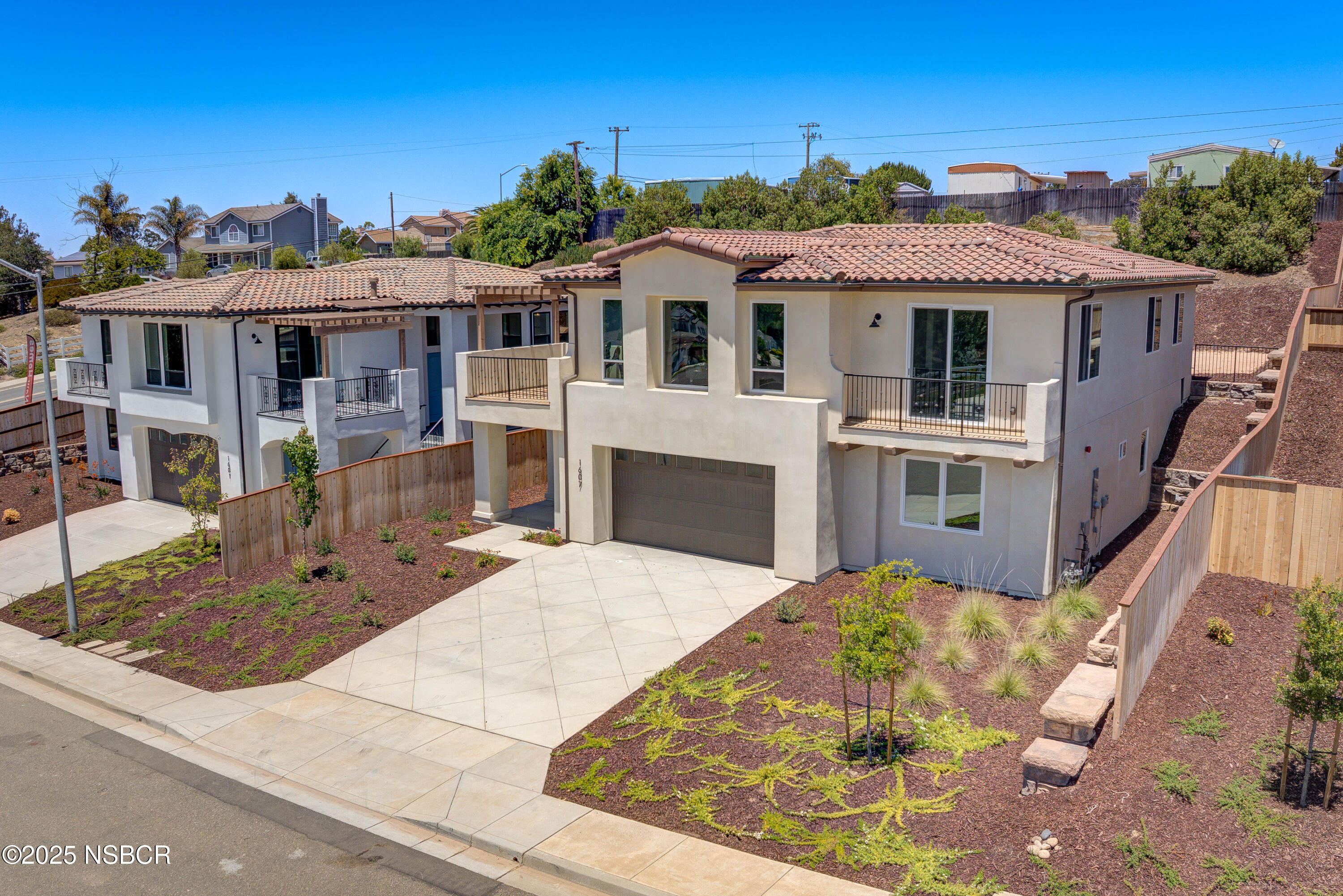 1607 Tuscan Way Santa Maria, CA 93455 - Photo 2 of 37 a view of a white house with a small yard and potted plants