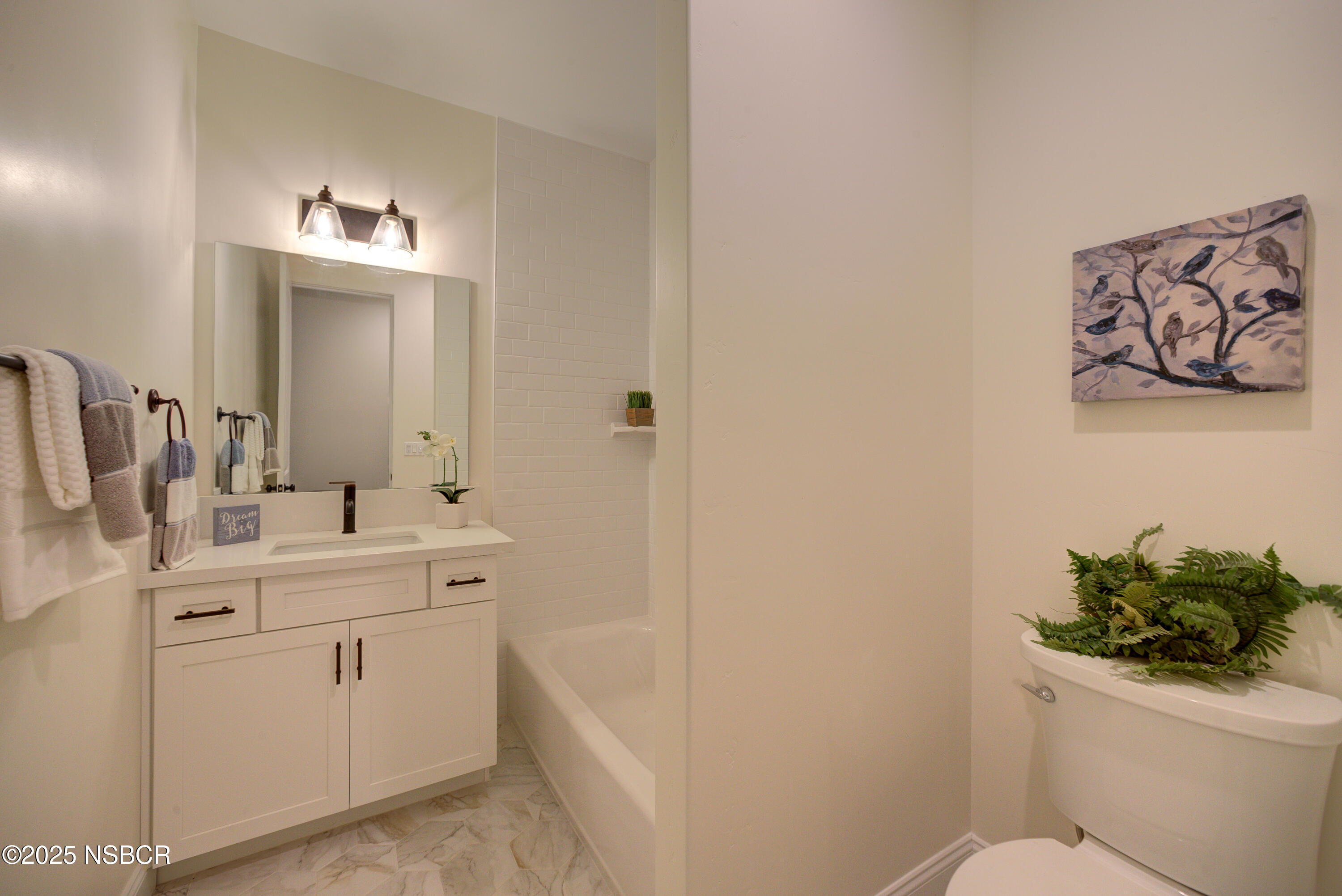 1607 Tuscan Way Santa Maria, CA 93455 - Photo 25 of 37 a bathroom with a toilet sink vanity and mirror