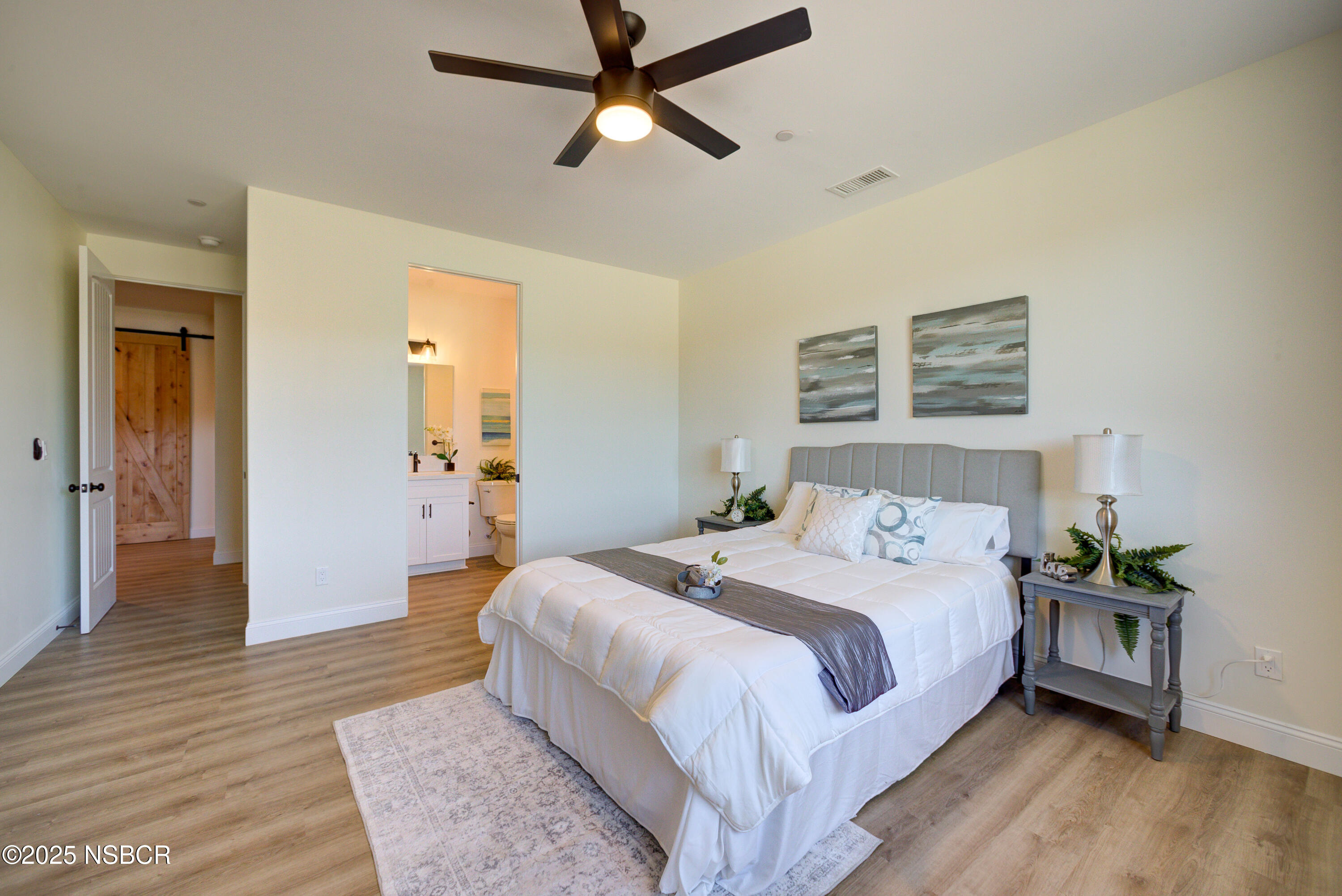 1607 Tuscan Way Santa Maria, CA 93455 - Photo 28 of 37 a bedroom with a bed and a chandelier