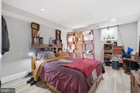 a kitchen with a sink cabinets and wooden floor