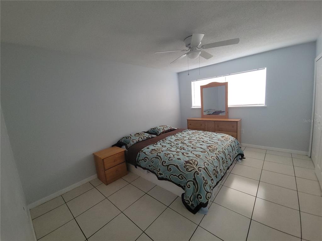 5317 Curry Ford Road, Unit 20 Orlando, FL 32812 - Photo 11 of 18 a bedroom with a bed and a window