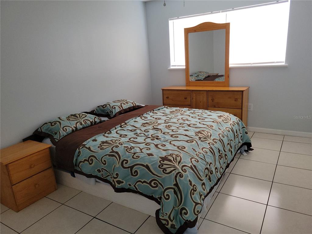 5317 Curry Ford Road, Unit 20 Orlando, FL 32812 - Photo 12 of 18 a bedroom with a bed and window