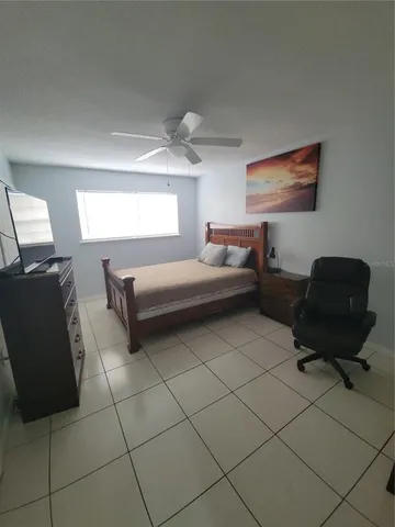 a bedroom with a bed and a chair