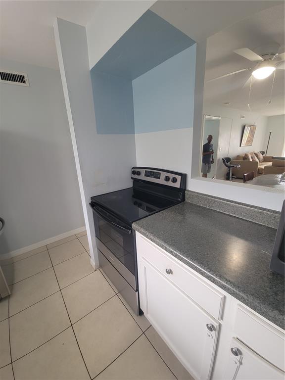 5317 Curry Ford Road, Unit 20 Orlando, FL 32812 - Photo 17 of 18 a kitchen with a stove and a sink