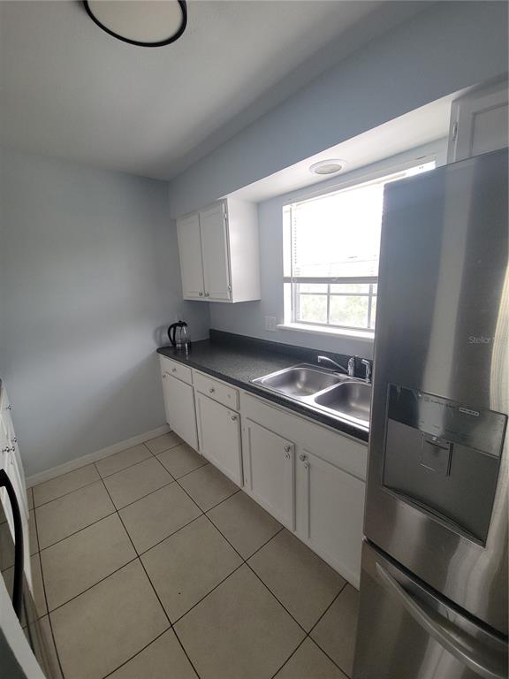 5317 Curry Ford Road, Unit 20 Orlando, FL 32812 - Photo 18 of 18 a kitchen with granite countertop a sink and a stove top oven