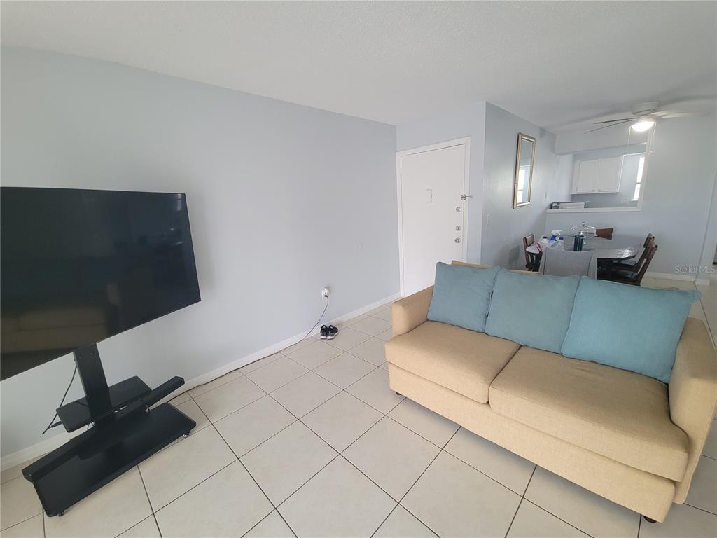 5317 Curry Ford Road, Unit 20 Orlando, FL 32812 - Photo 3 of 18 a living room with furniture and a flat screen tv