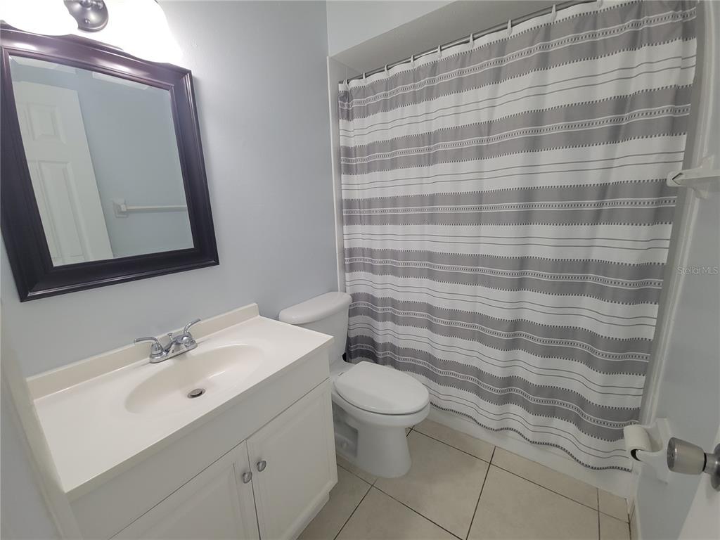5317 Curry Ford Road, Unit 20 Orlando, FL 32812 - Photo 9 of 18 a bathroom with a sink a toilet and mirror