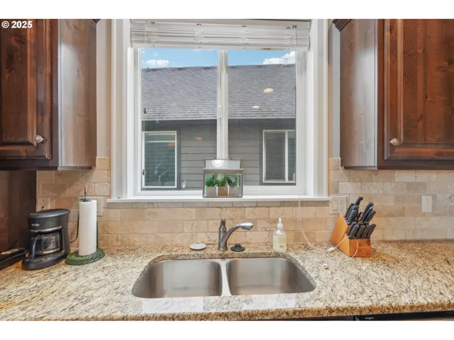 a kitchen with stainless steel appliances granite countertop a sink stove and cabinets