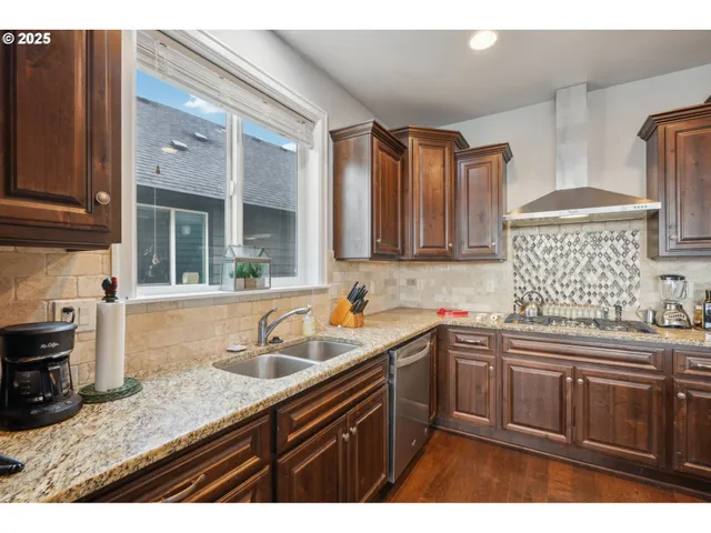 a kitchen with a sink dishwasher and cabinets