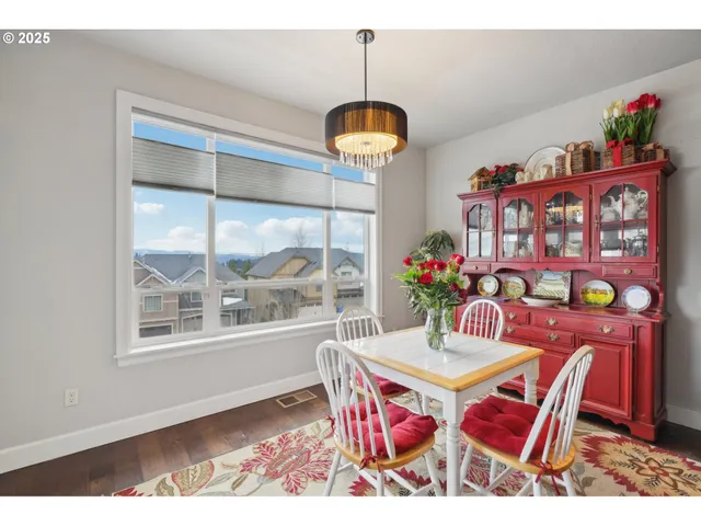 a view of a dining room with furniture wooden floor and a chandelier