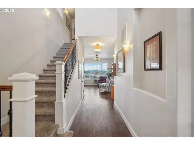 a view of entryway and hall with wooden floor