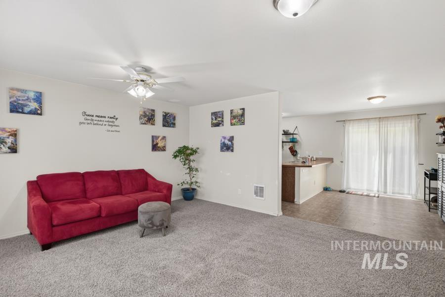 1337 Bristol Road Moscow, ID 83843 - Photo 7 of 28 Spacious living area featuring light gray carpeting and white walls