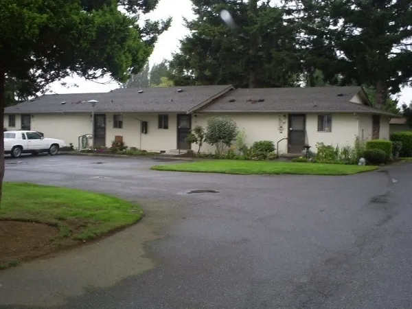 a front view of a house with a garden and yard