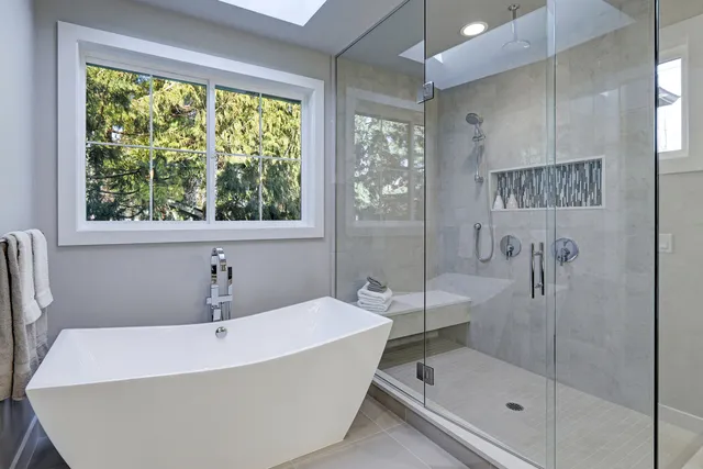 a bathroom with a bathtub and shower