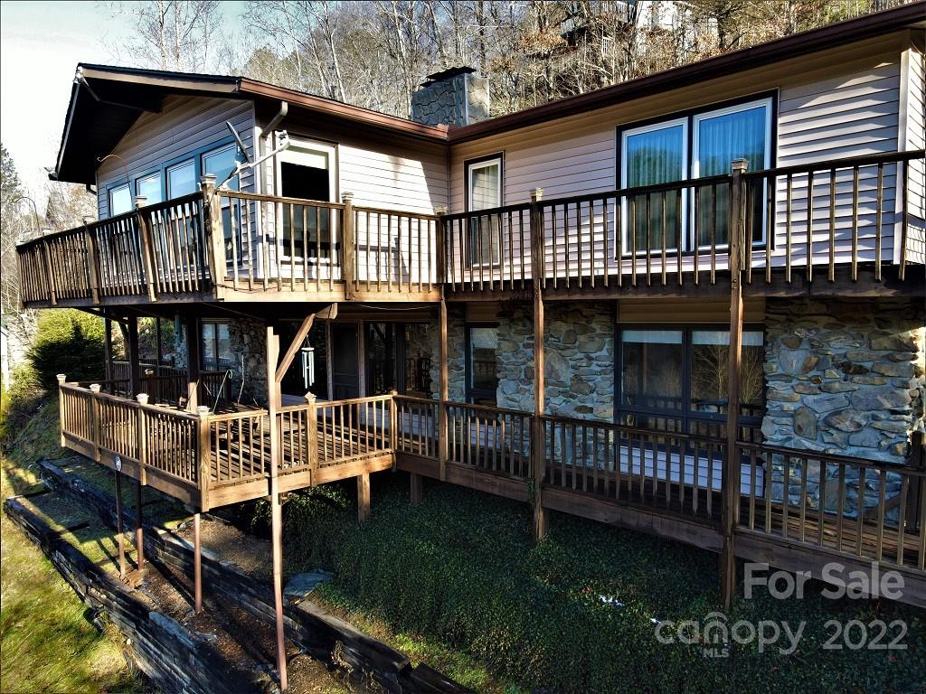 a view of a house with backyard and deck