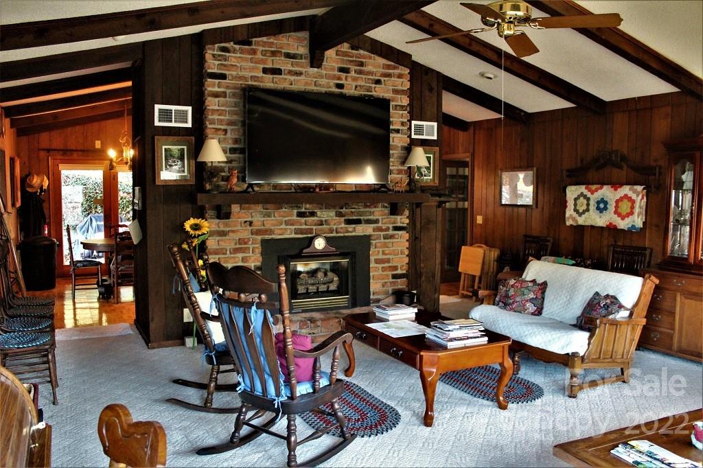 789 Tobacco Branch Road Almond, NC 28702 - Photo 11 of 42 a living room with furniture and a flat screen tv