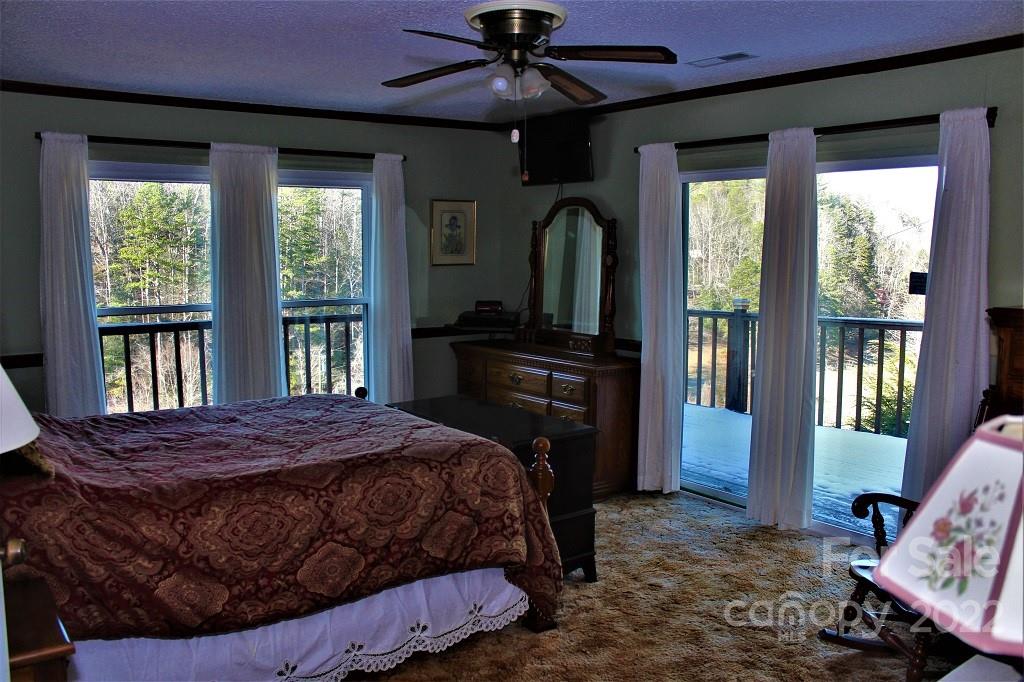 789 Tobacco Branch Road Almond, NC 28702 - Photo 12 of 42 a bedroom with a bed and a window