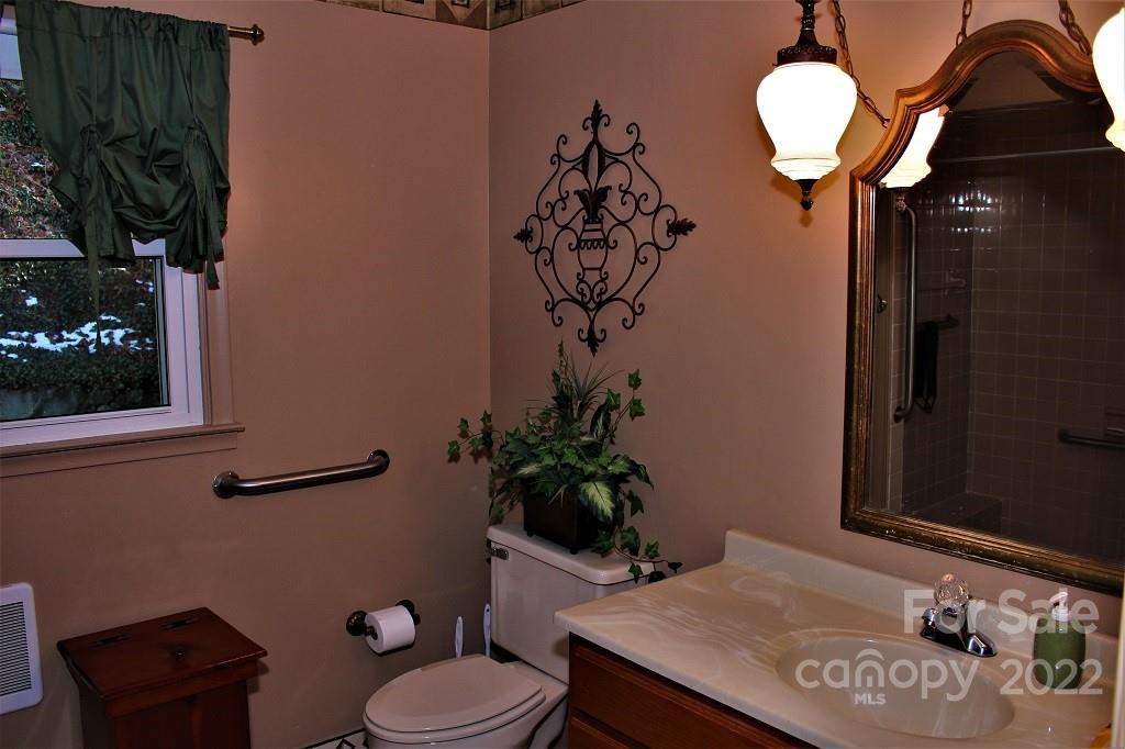789 Tobacco Branch Road Almond, NC 28702 - Photo 14 of 42 a bathroom with a sink a toilet and mirror