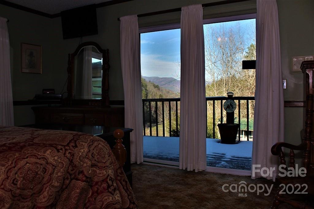 789 Tobacco Branch Road Almond, NC 28702 - Photo 16 of 42 a bed sitting in front of a window