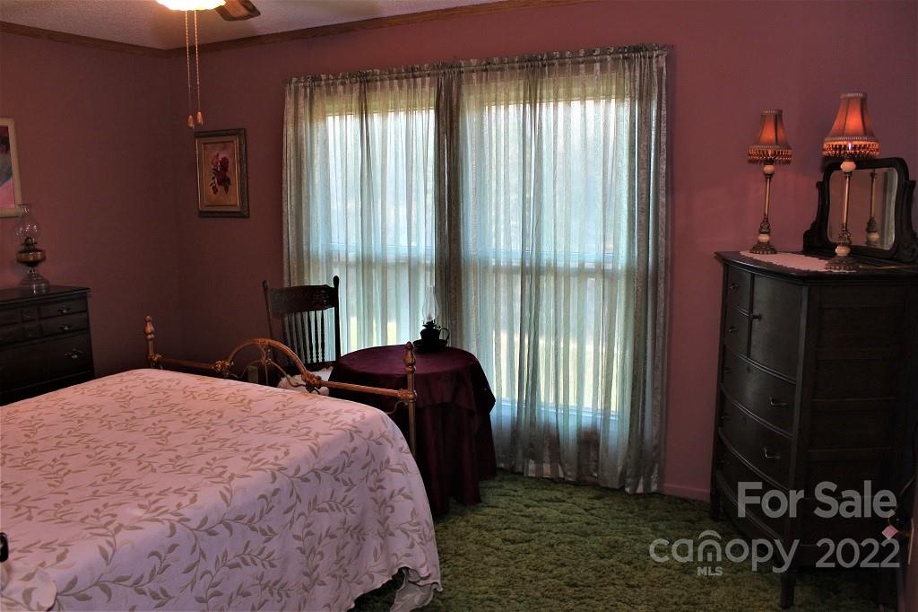 789 Tobacco Branch Road Almond, NC 28702 - Photo 18 of 42 a bedroom with a bed and a window