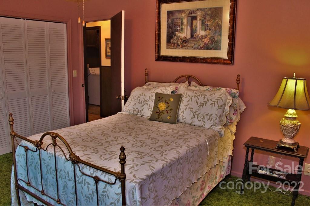 789 Tobacco Branch Road Almond, NC 28702 - Photo 19 of 42 a bedroom with a bed and painting on the wall