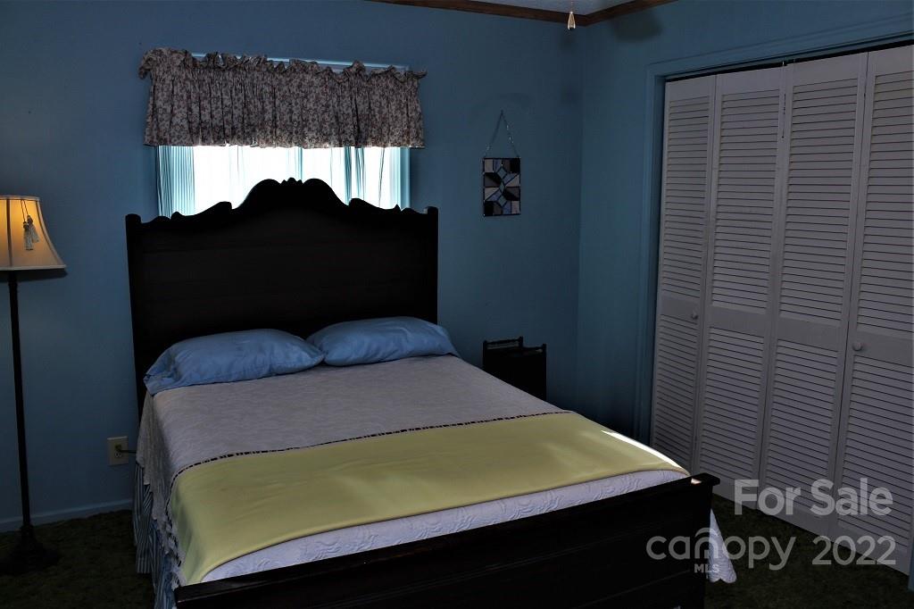 789 Tobacco Branch Road Almond, NC 28702 - Photo 21 of 42 a bedroom with a bed and a window