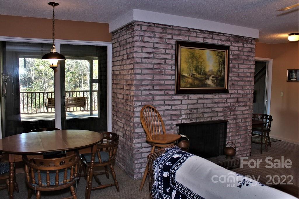 789 Tobacco Branch Road Almond, NC 28702 - Photo 25 of 42 a living room with furniture a window and a fireplace