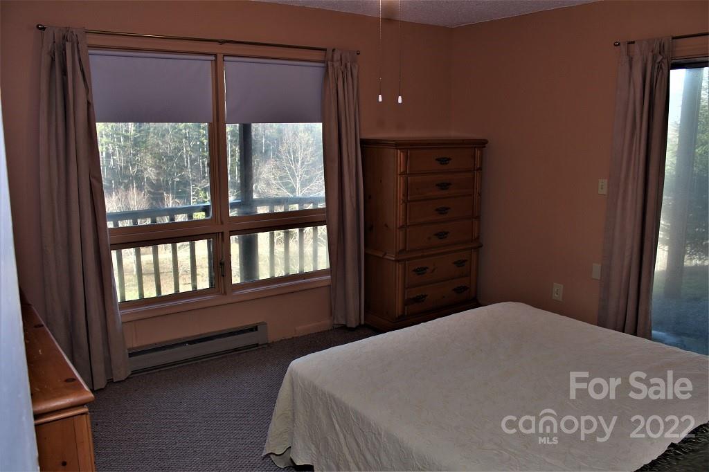 789 Tobacco Branch Road Almond, NC 28702 - Photo 26 of 42 a bedroom with a bed and a window