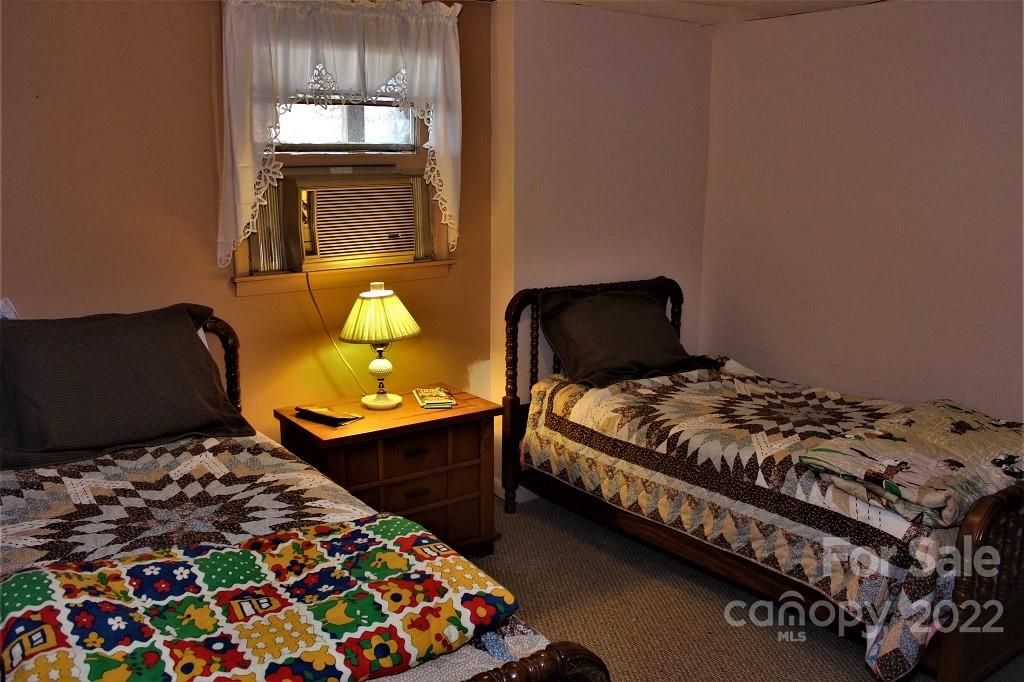 789 Tobacco Branch Road Almond, NC 28702 - Photo 27 of 42 a bedroom with a bed and window
