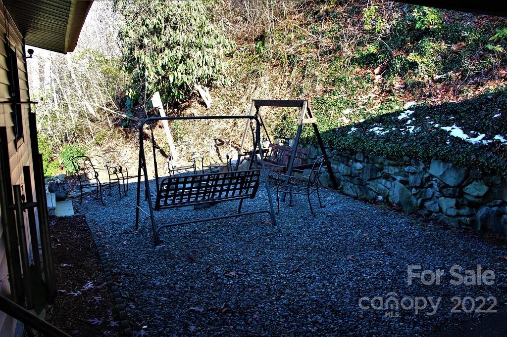 789 Tobacco Branch Road Almond, NC 28702 - Photo 7 of 42 a view of a yard with swing plants and wooden fence