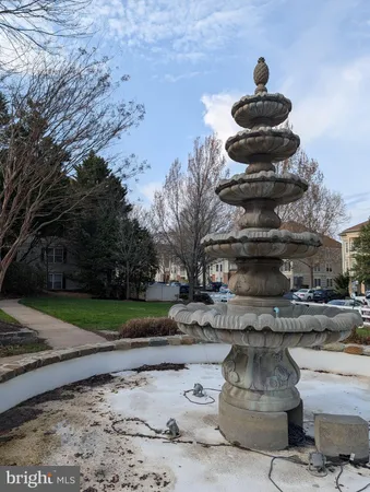 a view of a fountain in the middle of a yard