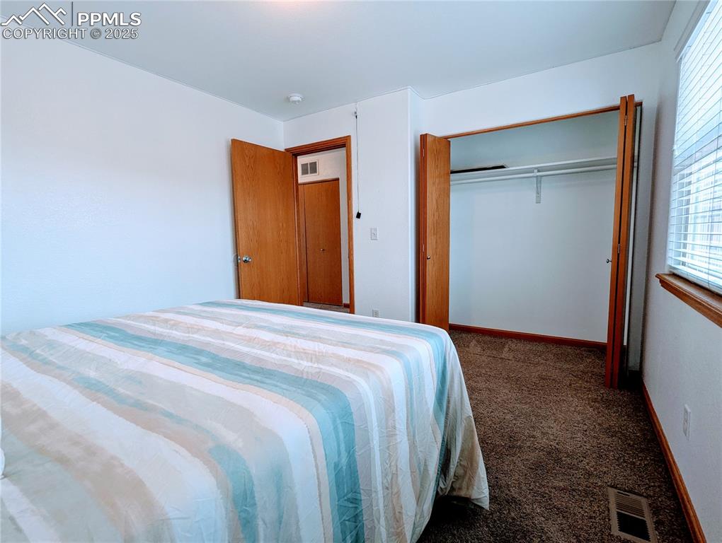 7326 Legacy Point Fountain, CO 80817 - Photo 11 of 18 a bedroom with a bed and a window