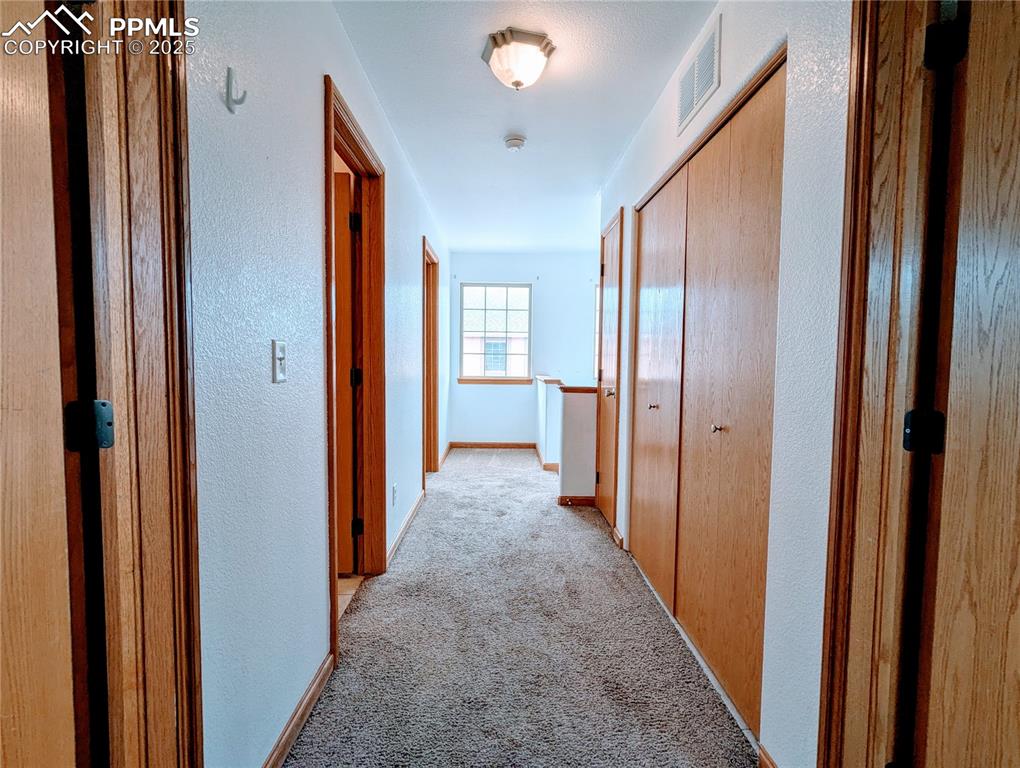 7326 Legacy Point Fountain, CO 80817 - Photo 7 of 18 a view of a hallway with wooden shelves