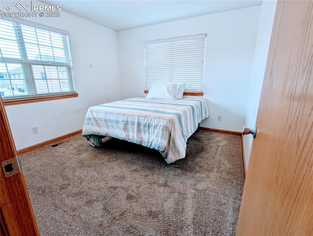 7326 Legacy Point Fountain, CO 80817 - Photo 10 of 18 a spacious bedroom with a bed and a window