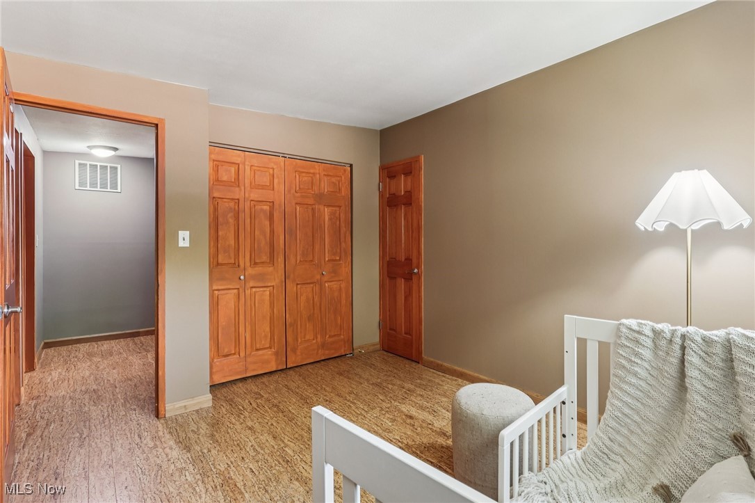 6568 Sherborn Road Parma Heights, OH 44130 - Photo 25 of 47 Bedroom featuring a closet, baseboards, and light carpet
