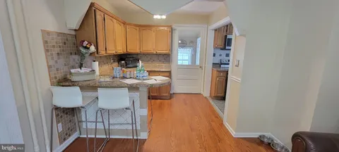 a kitchen with stainless steel appliances granite countertop a refrigerator a stove top oven a sink and dishwasher