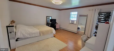 a bedroom with a bed and a mirror