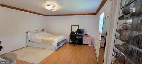 a bedroom with a bed and a large mirror