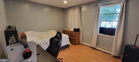 a bedroom with a bed and a desk in it