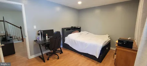 a bed sitting in a bedroom next to a window