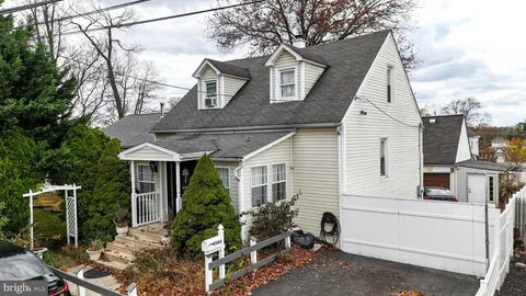 a view of a white house next to a yard