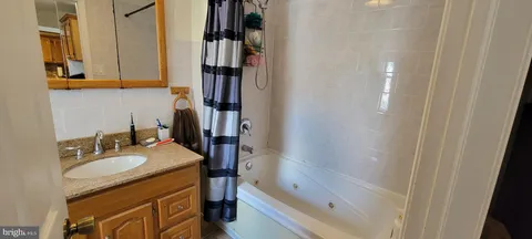 a spacious bathroom with a toilet sink and mirror