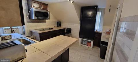 a kitchen with a sink stove and microwave