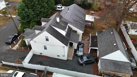 a front view of a house with plants