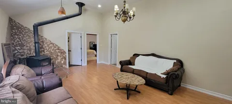 a living room with furniture a window and a flat screen tv