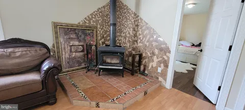 a kitchen with a table chairs refrigerator and cabinets