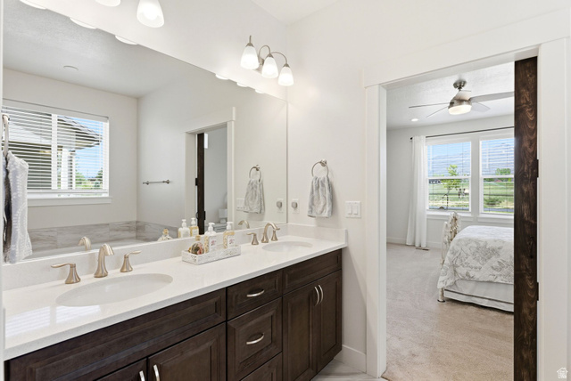108 West Monte Rosa Lane Midway, UT 84049 - Photo 20 of 48 Double vanity featuring dual undermount sinks, brushed nickel faucets, and dark wood-finish cabinetry with silver-tone hardware